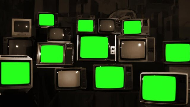 Nine Vintage Televisions with Green Screens in a Retro TV Stack Installation. Sepia Tone. Zoom In. You can replace green screen with the footage or picture you want with &ldquo;Keying&rdquo; effect in AE. 4K.