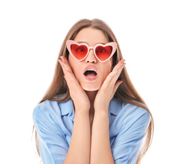 Surprised young woman in stylish heart-shaped sunglasses on white background