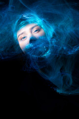 Portrait of young woman amid light painting , Over Black Background. Long exposure photo without photoshop, light drawing at long exposure