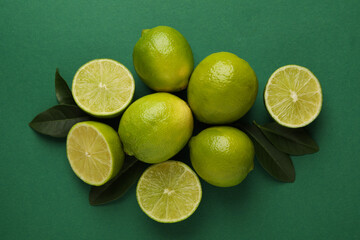 Ripe lime on green background, top view