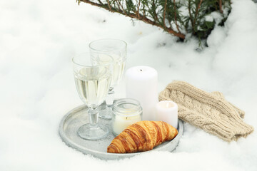 Cozy concept with champagne and croissant outdoor in winter