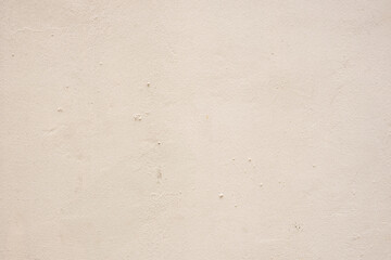 Detail texture of an old weathered light pink painted wall in soft light. Stock Photo.