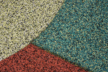 Detail cropped texture of a weathered and dirty rubber floor of a children's playground. Stock Photo.