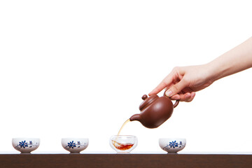 A hand in pouring tea closeup