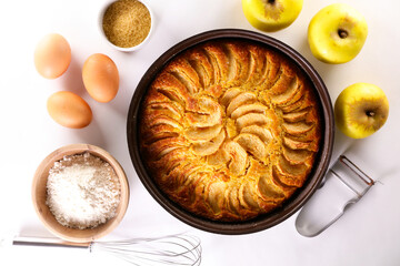 homemade apple pie and ingredient on white background