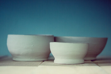 Ceramic clay products stand on the shelf close-up.