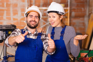 Two professional builders with thumbs up. High quality photo