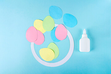 DIY and kids creativity. Step by step instruction: how to make paper easter wreath. Step4 cut out egg blanks from multi-colored paper. Childrens handmade Easter craft.
