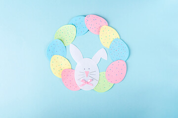 DIY and kids creativity. Step by step instruction: how to make paper easter wreath. Step9 glue paper eggs and bunny to circle like wreath. Childrens handmade Easter craft.