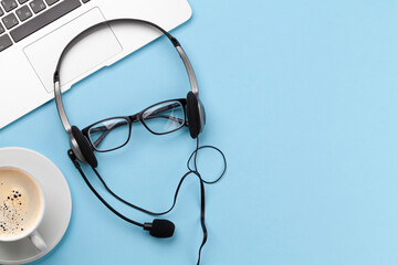 Office desk with headset and laptop. Work from home