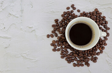 A cup of coffee with coffee beans.