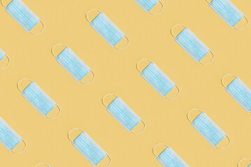 Seamless pattern from a protective medical mask on a yellow background.