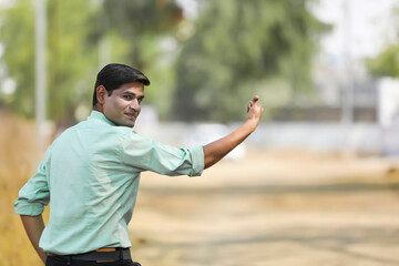 Fototapeta premium Young indian man asking lift for going to home