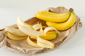 Ripe bunch of bananas in paper bag. Healthy eating concept