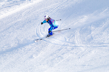 
Skier skiing downhill in high mountains  - obrazy, fototapety, plakaty