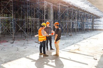 Construction concept of Engineer and Architect working at Construction Site with blue print