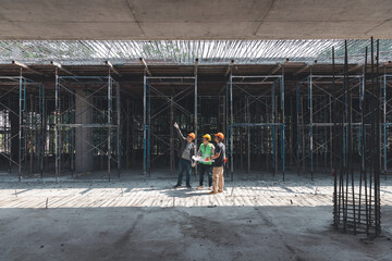 Construction concept of Engineer and Architect working at Construction Site with blue print