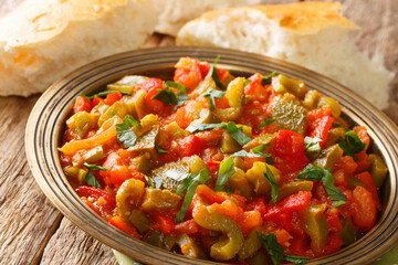 Vegetarian Moroccan Taktouka salad of pepper and tomato close-up in a plate on the table. horizontal