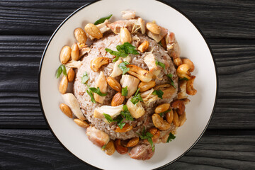 Authentic cinnamon and ground beef rice recipe topped with chicken and nuts close-up in a plate on the table. horizontal top view from above