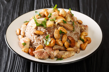 Traditional Lebanese cinnamon rice and chicken dish is called Riz bi-Djaj closeup in the plate on the table. horizontal