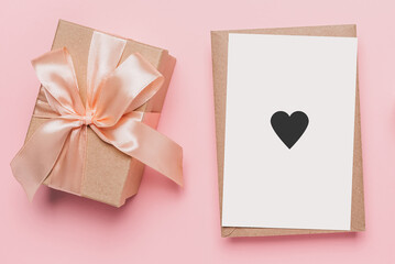 Gifts with note letter on isolated pink background, love and valentine concept with heart