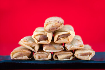 Fried spring rolls at the beginning of spring on a red background