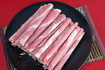 A plate of fresh hot pot beef rolls