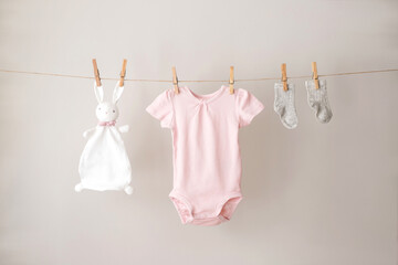 Baby clothes hanging on the rope.