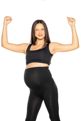 Fototapeta na wymiar a pregnant happy young woman in black leggings and a shirt showing her biceps