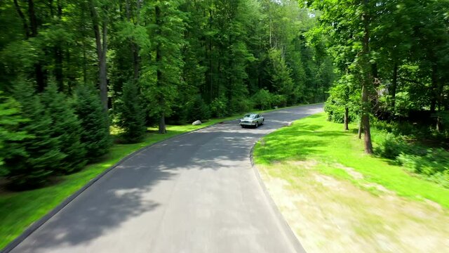 Following Behind the James Bond Aston Martin DB5 Sports Car Around a Bend