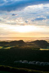 Beautiful view: Romantic sunrise in Saxon Switzerland in summer with a wide view to the horizon