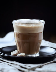 Coffee with milk on dark wooden background. Close up.	