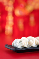 Fototapeta na wymiar A plate of festival dumplings on a red background