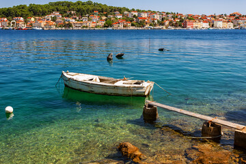 Fototapeta na wymiar boat moored at the wooden pier in harbour of Losinj town, Croatia.