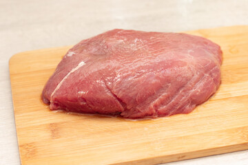 Raw beef meat on a cutting wooden board