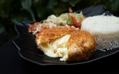 Camembert schnitzel with rice and salad