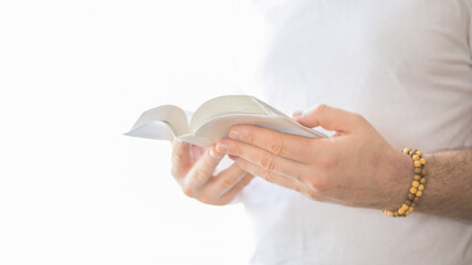 The Christian holds the Bible in his hands. Reading the bible. The concept of faith, spirituality and religion