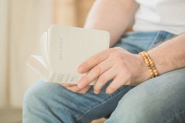 Fototapeta premium The Christian holds the Bible in his hands. Reading the bible. The concept of faith, spirituality and religion