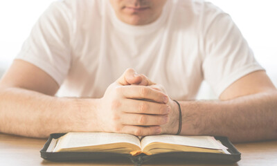 Reading the bible. Prayer. Hands folded in prayer concept. The concept of faith, spirituality and religion