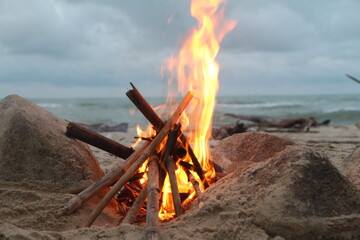 campfire with sea beach background in evening storm season 