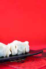 A plate of festival dumplings on a red background