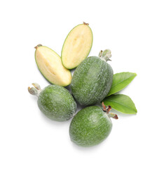 Cut and whole feijoas with leaves on white background, top view