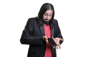 Portrait of a young man with long hair and a goatee in a black leather jacket and red T-shirt with a phone in his hands isolated on a white background. The concept of human emotions.