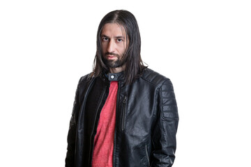Portrait of a young man with long hair and a goatee in a black leather jacket and red T-shirt isolated on a white background. Facial expression, place for text.