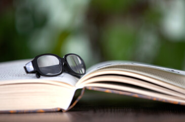 An open book and glasses on it