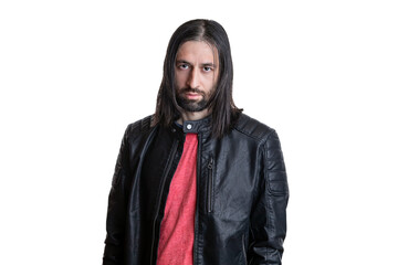 Portrait of a young man with long hair and a goatee in a black leather jacket and red T-shirt isolated on a white background. Facial expression, place for text.