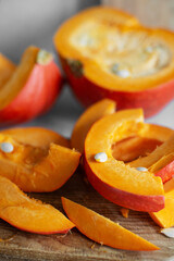 Just cut for meal preparing pumpkin slices on cutting board real photo made at authentic kitchen