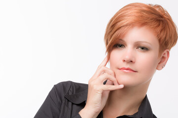 Portrait of a seriously looking young woman with red hair
