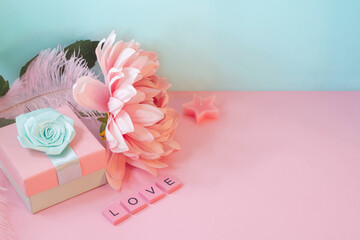 Side view on a table with present and decorations. Word love made of wooden letters