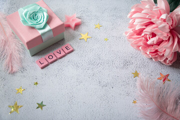 Top view on a table with present and decorations. Word love made of wooden letters